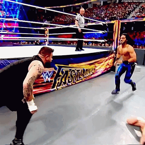 Two Men Wrestling in Ring with Referee