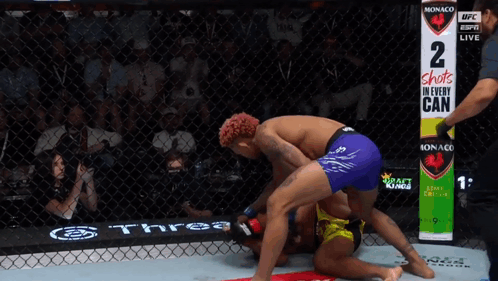 Two Men Wrestling In Ring With Sign 2 Shots In Every Can GIF