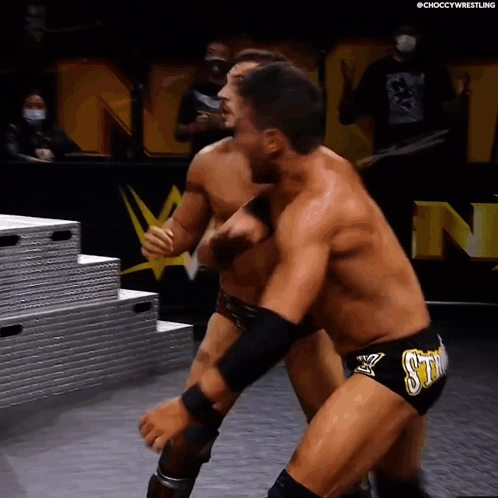 Two Men Wrestling in Ring With Sting Shorts