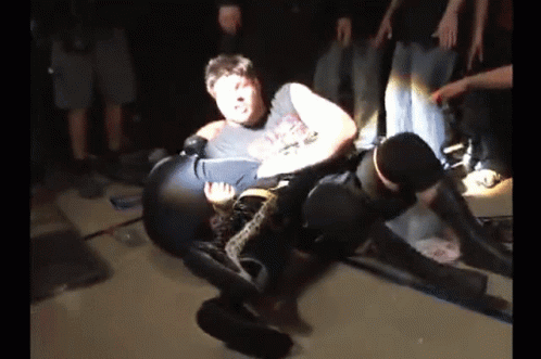 Two Men Wrestling, One in 'A' T-Shirt