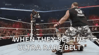 Two Men Wrestling When They See The Ultra Rare Belt GIF