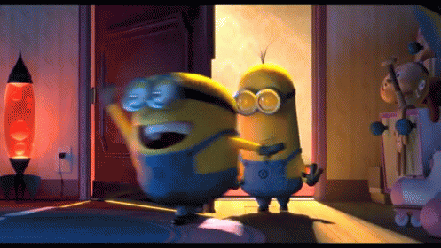 Two Minions Are Hugging Each Other In A Room With A Lamp In The Background GIF
