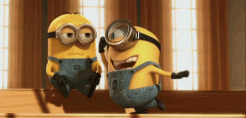 Two Minions In Goggles And Overalls Together GIF