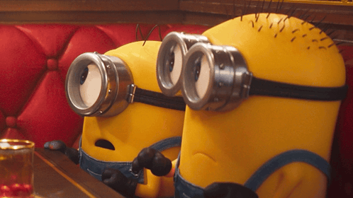 Two Minions Wearing Goggles on Red Couch