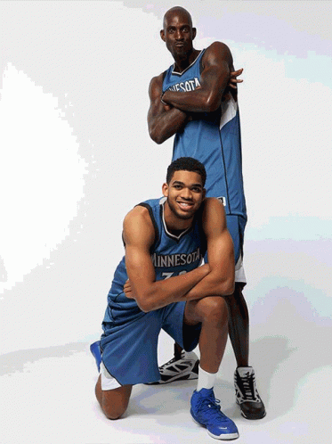 Two Minnesota Basketball Players Are Posing For A Picture GIF