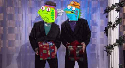 Two Monsters In Suits Are Holding Presents In Front Of A Curtain GIF