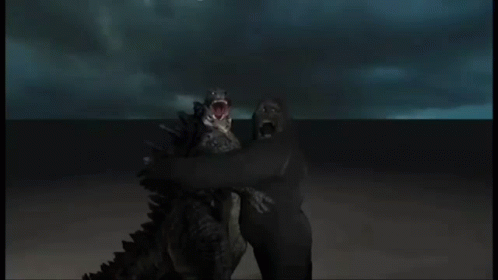 Two Monsters With Their Mouths Wide Open Are Standing Next To Each Other GIF