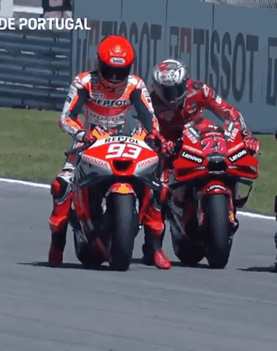Two Motorcycle Racers Are Racing On A Track And One Has The Number 93 On The Front Of His Motorcycle GIF