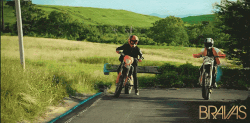 Two Motorcycle Riders on Road With Bravas