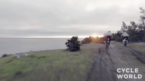 Two Motorcycles Riding Dirt Road