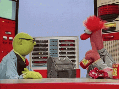 Two Muppets Are Sitting At A Table With A Machine That Says Computer Data Store GIF