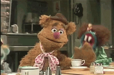 Two Muppets Sitting at Table