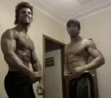 Two Muscular Men Standing Shirtless GIF