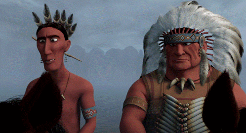 Two Native Americans Standing One With Feathered Headdress