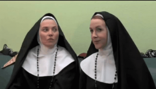 Two Nuns Sitting on Green Couch