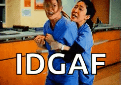 Two Nurses Are Hugging Each Other In A Hospital And The Words Idgaf Are Above Them . GIF