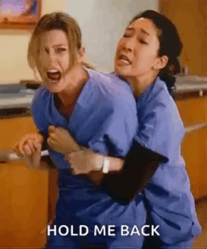 Two Nurses Are Hugging Each Other In A Hospital Room And Screaming . GIF