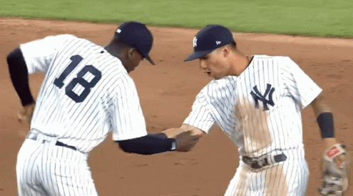 Two Ny Yankees Baseball Players Shake Hands On The Field GIF