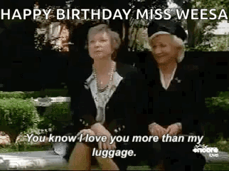 Two Older Women Sitting on Park Bench Talking