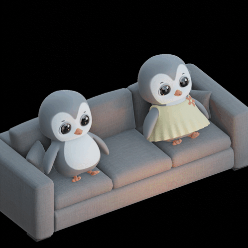 Two Penguins on Grey Couch One in Yellow Dress