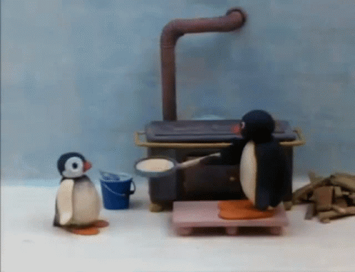 Two Penguins Standing by Stove