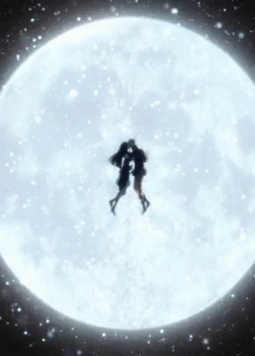 Two People Are Kissing In Front Of A Full Moon . GIF