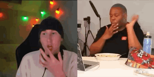 Two People Are Sitting At A Table With A Laptop And A Bowl Of Food . GIF