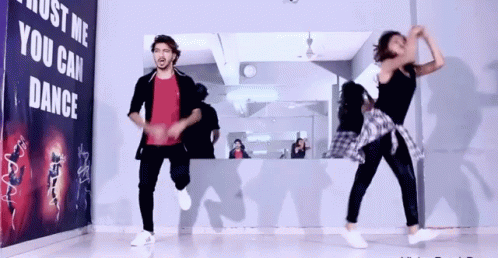 Two People Dancing In Front Of Just Me You Can Dance Sign GIF