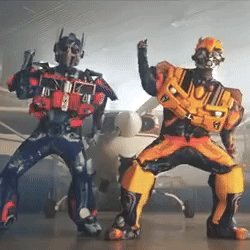Two People Dressed as Transformers Standing Together