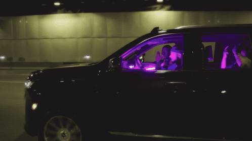 Two People In A Black Suv With Purple Lights On GIF