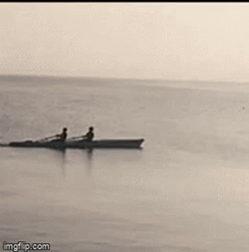 Two People In A Boat In Ocean GIF