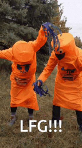 Two People In Orange Costumes With The Word Lfg On The Bottom Right GIF