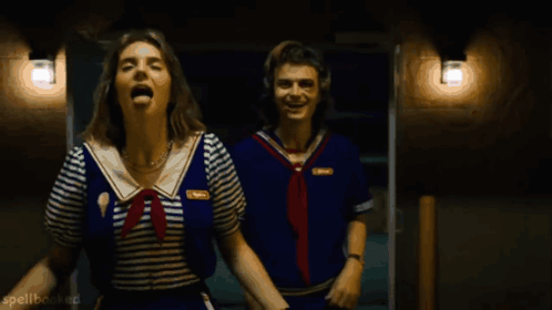 Two People In Sailor Outfits Are Laughing And Spellbooked Is Visible In The Bottom Right Corner GIF