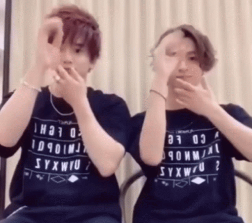 Two People In Syxwu Shirts Covering Faces GIF