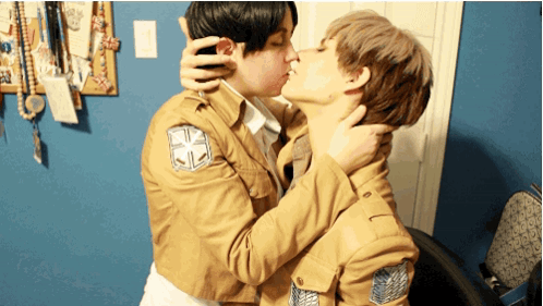 Two People Kissing With One Wearing A Jacket With A Cross On The Sleeve GIF