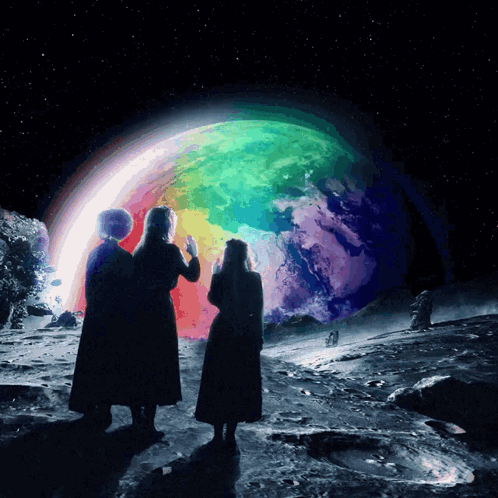 Two People Looking At A Rainbow Colored Planet GIF