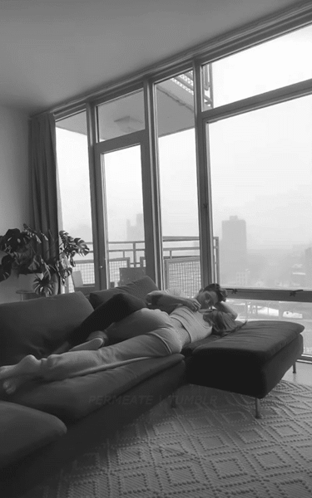 Two People Lying on Couch