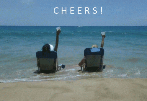 Two People on Beach Feet in Air Cheers