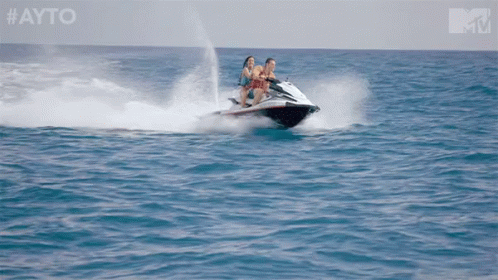 Two People Riding A Jet Ski In The Ocean With The Hashtag #Ayo GIF