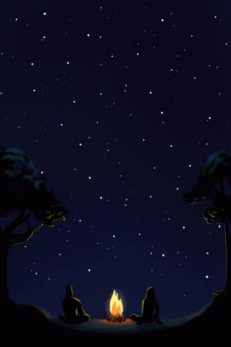 Two People Sit Around A Campfire Under A Starry Sky GIF