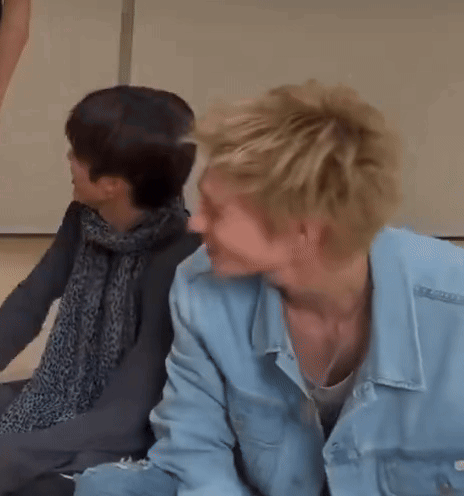 Two People Sitting Next to Each Other on Floor