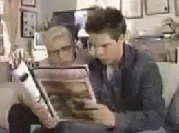 Two People Sitting On Couch Reading Magazines GIF