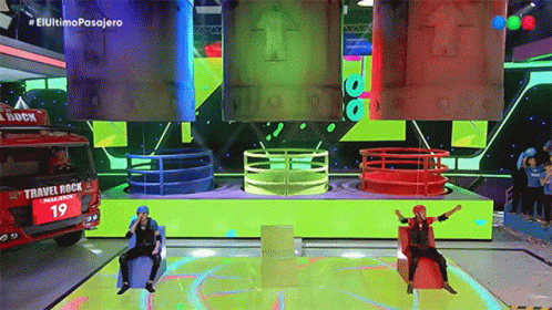 Two People Sitting on Stage With Travel Rock Truck