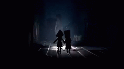 Two People Standing in Dark Room