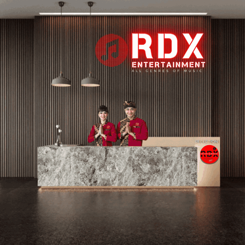 Two People Standing In Front Of A Sign That Says Rdx GIF