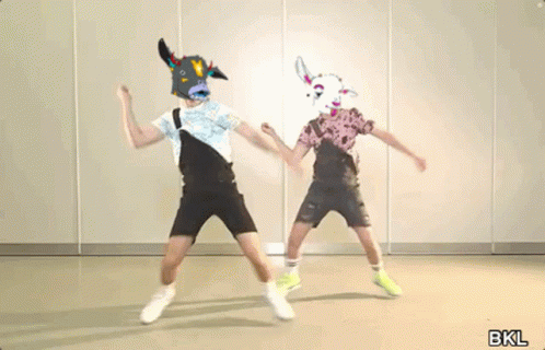 Two People Wearing Cow Masks Dancing in Room