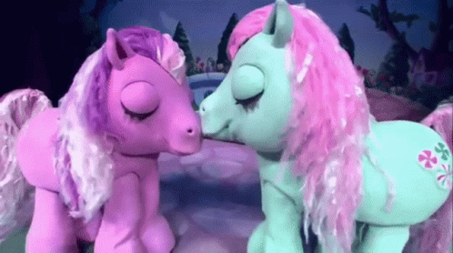 Two Pink And Blue Ponies Are Kissing Each Other GIF