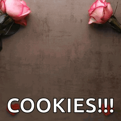 Two Pink Roses Are Sitting On A Table Next To The Words Cookies GIF