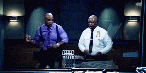 Two Police Officers Are Dancing In A Dark Room And One Has A Nyps Patch On His Shirt GIF