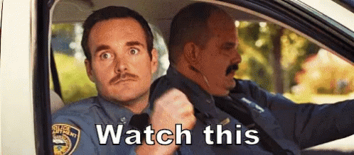 Two Police Officers Are Sitting In A Car With The Words Watch This Written On The Bottom . GIF